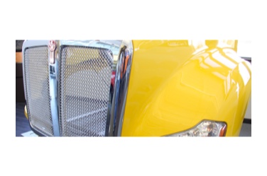 yellow and chrome colored front end of heavy duty truck made from composite materials