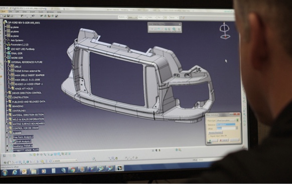 man desigining 3d part on computer screen