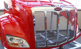 red and chrome colored front end of heavy duty truck made from composite materials