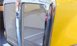 yellow and chrome colored front end of heavy duty truck made from composite materials