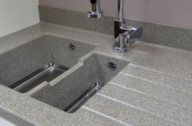 countertop made composite materials surrounding dual sink