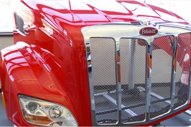 red and chrome colored front end of heavy duty truck made from composite materials